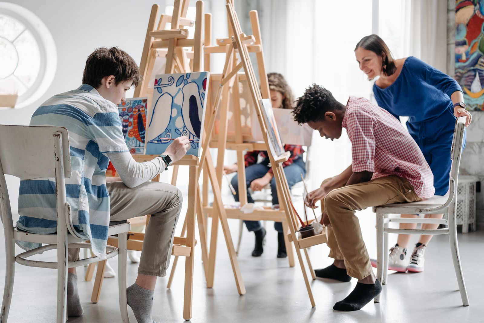 Children painting together during an art class