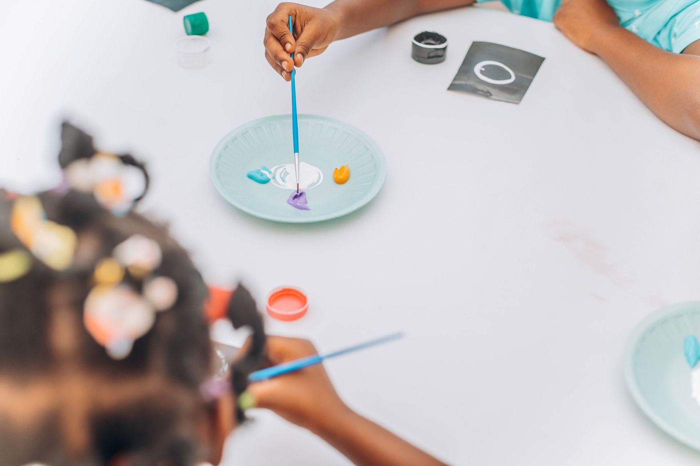Children's hands working with colourful paint