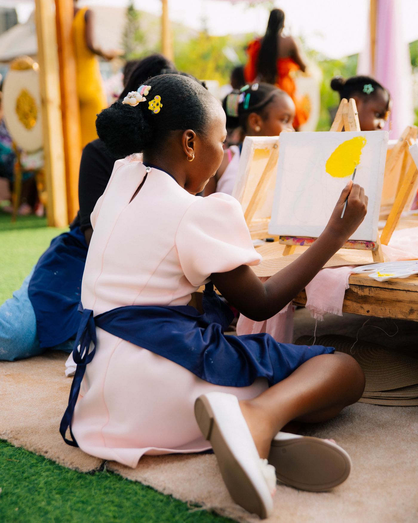 Children painting outdoors in a park